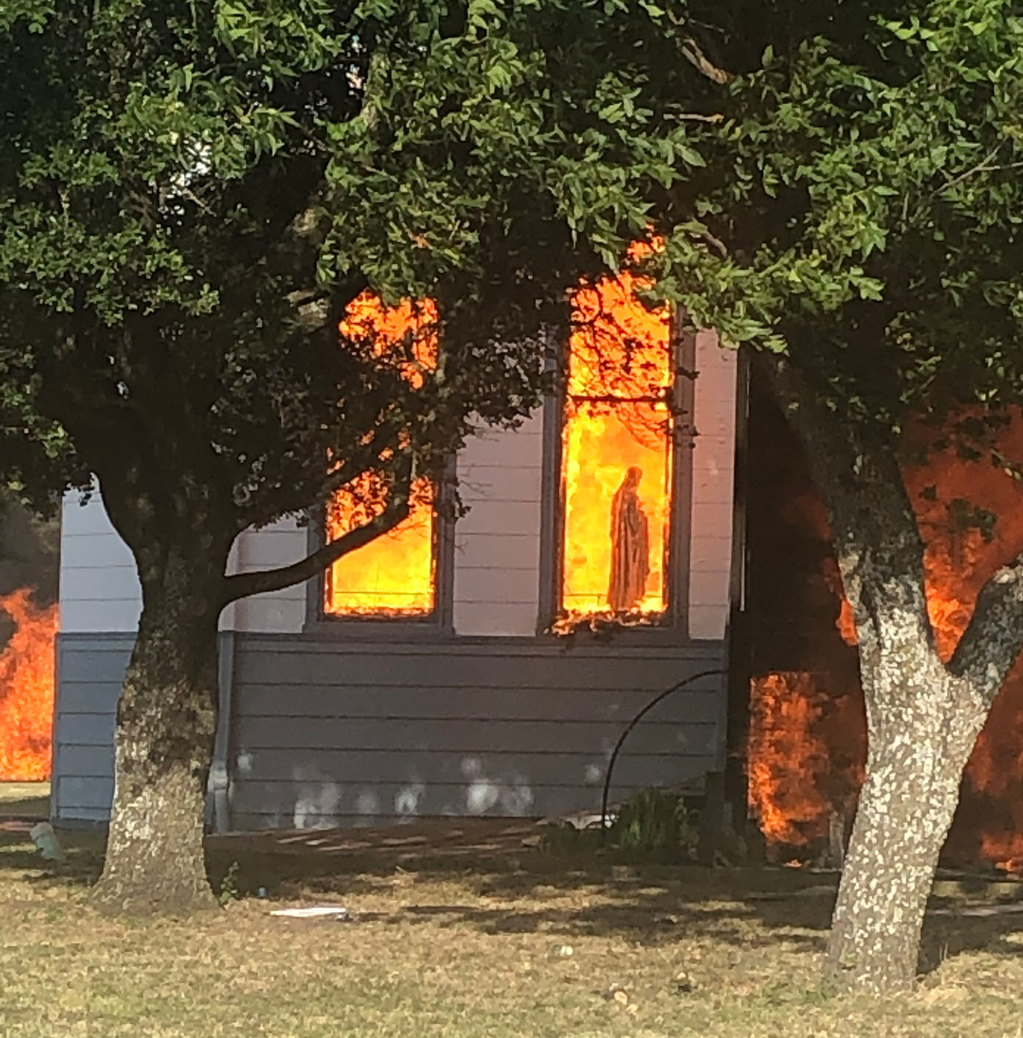 A statue of Mary is seen amid flames through a window in the Church of the Visitation in Westphalia, Texas, July, 29, 2019. The nearly 125-year old wooden church with bell towers on each side, burned to the ground that morning. Since 1883 the parish has served the Catholic community of southwestern Falls County, many of whom are descendents of immigrants from the northwest German region of Westphalia.